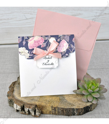 <p>Invitație de nuntă cu ornament floral pe clapa superioară și carton alb în partea inferioară. La interior modelul are un spațiu dedicat textului pe fundal alb și un chenar vărgat cu nuanțe albe și albastre închis și un ornament floral în colțul din stânga. Se pliază în trei pe orizontală și pe copertă se atașează o etichetă cu numele mirilor. În prețul invițatiei este inclus plic de culoarea roz pudrat.</p>