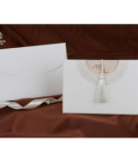 <p>Invitație de nuntă confecționată dintr-un carton alb destinat imprimării textului, accesorizat cu un ciucure alb pentru a ajuta glisarea invitației. Invitația este introdusă într-un carton de tip buzunar ce prezintă un model reliefat argintiu. Atunci cînd invitația este introdusă în buzunar se pot observa imprimate numele mirilor.</p>