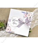 <p>Invitație de nuntă cu imprimeu floral. Cartonașul invitației se pliază în două părți pe verticală iar pe partea din spate este imprimat textul invitației. Coperta invitației este decorată cu o panglică de mătase gri și o etichetă pe care se printează numele mirilor. În prețul invitației este inclus plic.</p>